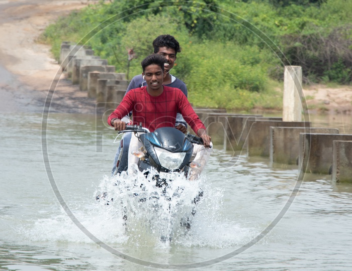 Bikers Crossing A Flooded Bridge in Rural Villages Of  Telangana