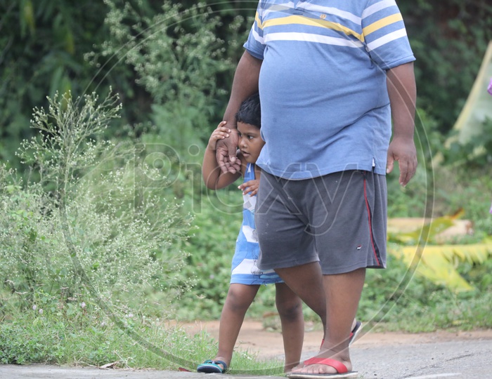 Indian Little girl walking with a Fat Man