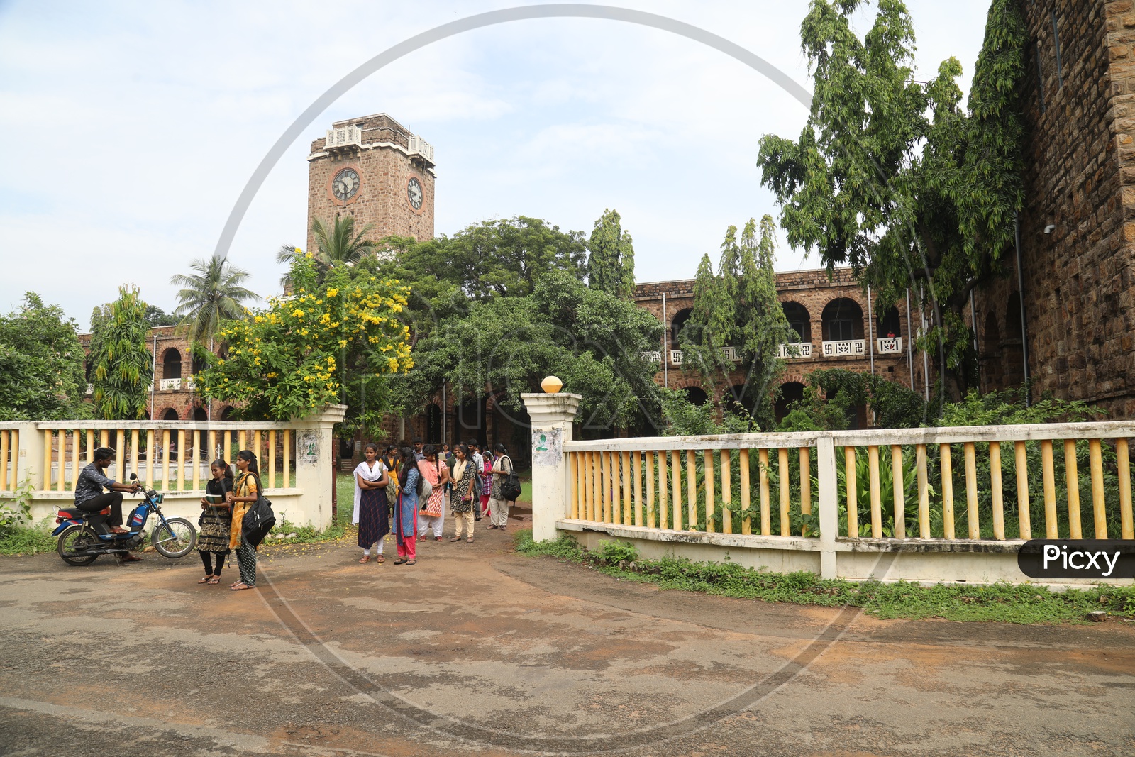 Students walking out of the entrance gate of the college