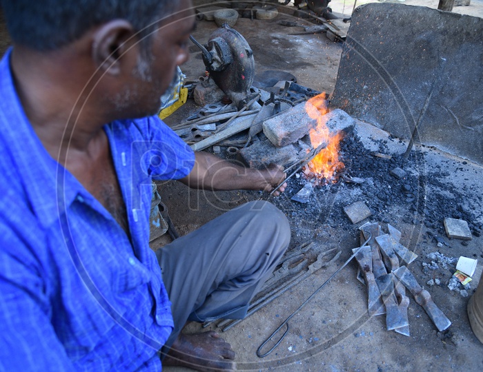 Indian Blacksmith Forges the Hot Iron Metal