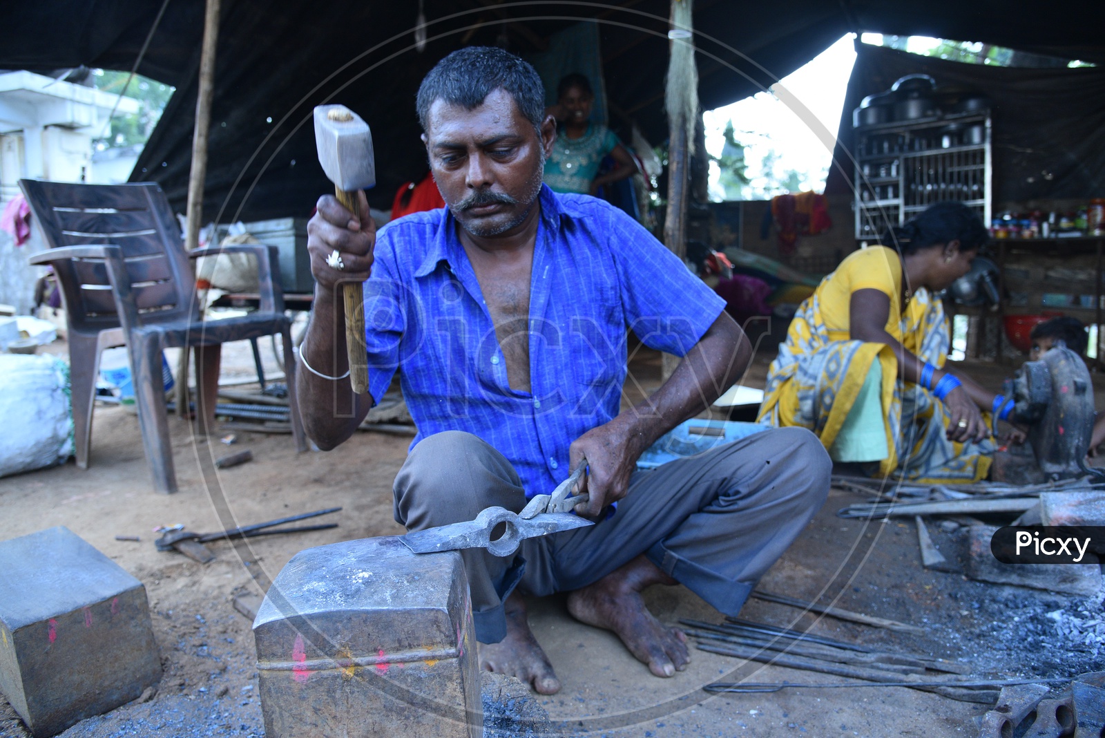 Indian Blacksmith Shaping the Iron Axe Blade using Hammer