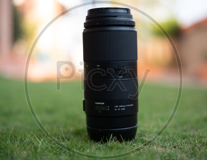 Tamron 100-400 mm DSLR Lens Over Lawn Grass Backdrop