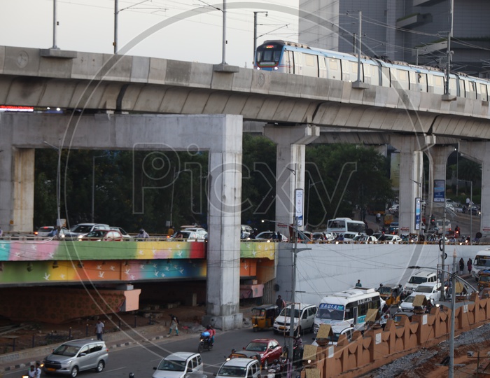 Hyderabad Metro train With Commuting Vehicles On Road And Flyover At Hi-Tech City Signal