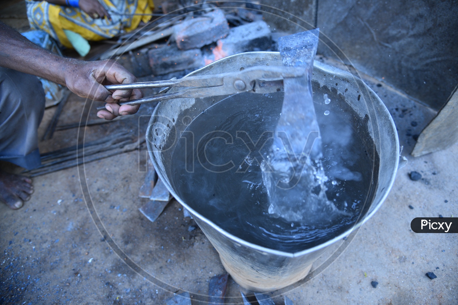 Indian Blacksmith Cooling the Hot Metal in Water