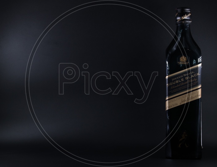 Johnnie Walker Double Black Scotch Bottle On An Isolated Black Background