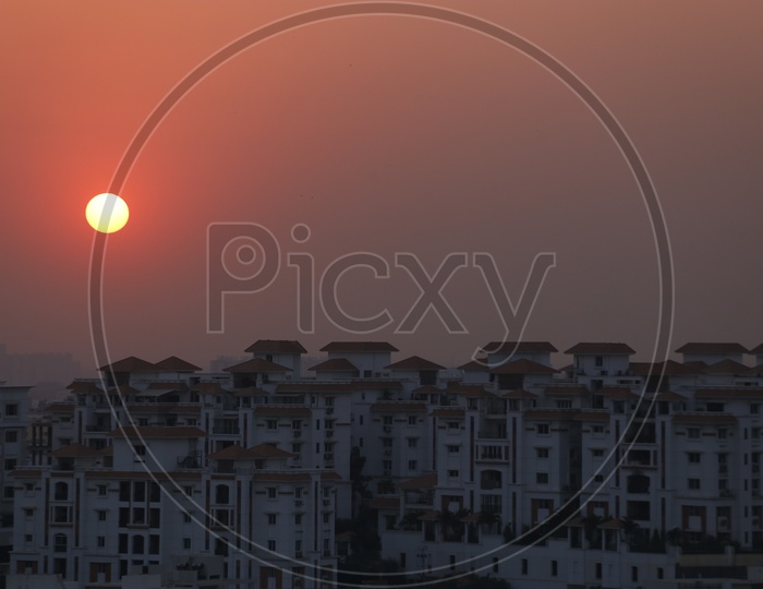 Sunset Over High Rise Buildings Or Apartments Closeup