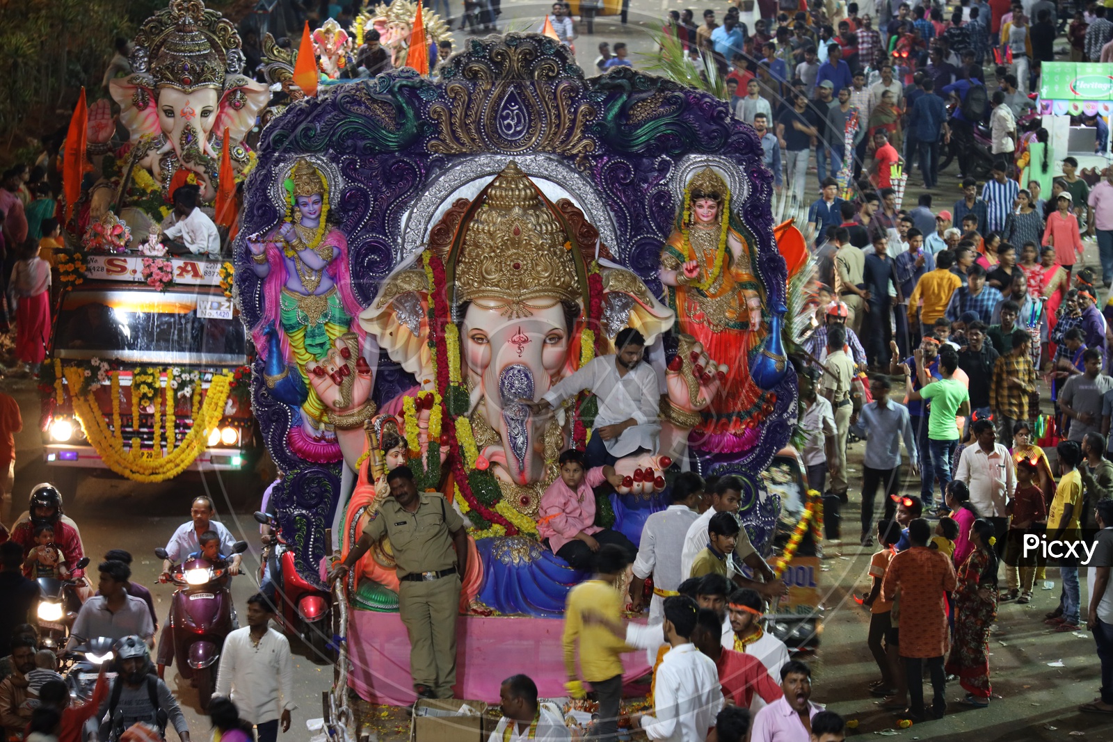 Image of Ganesh Idols In Trucks And Crowd Of Devotees At Tank Bund For ...