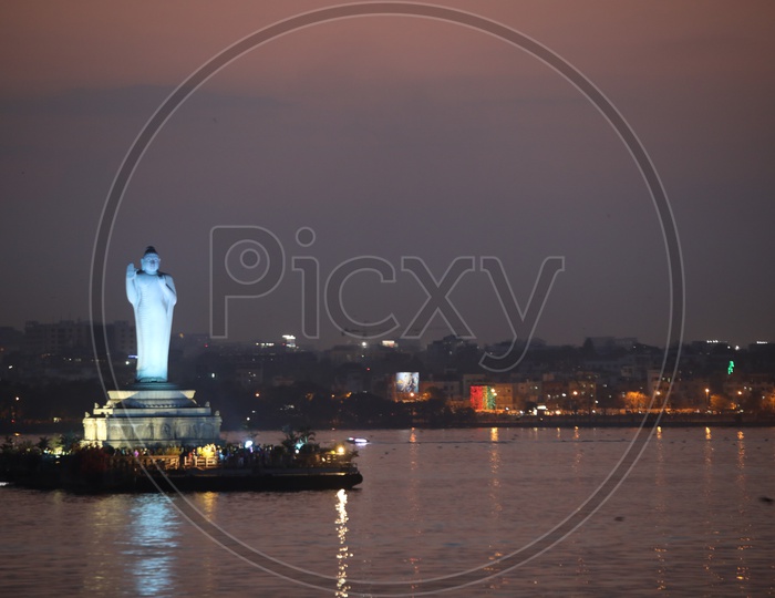 Buddha Statue In Hussain Sagar Lake With Colourful Lights Flare  In Night Time