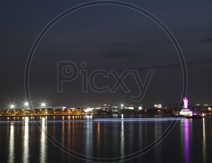 Buddha Statue In Hussain Sagar Lake With Colourful Lights Flare  In Night Time