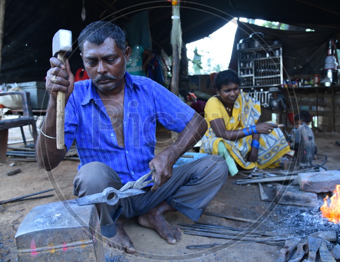 Indian Blacksmith Shaping the Iron Piece using Hammer