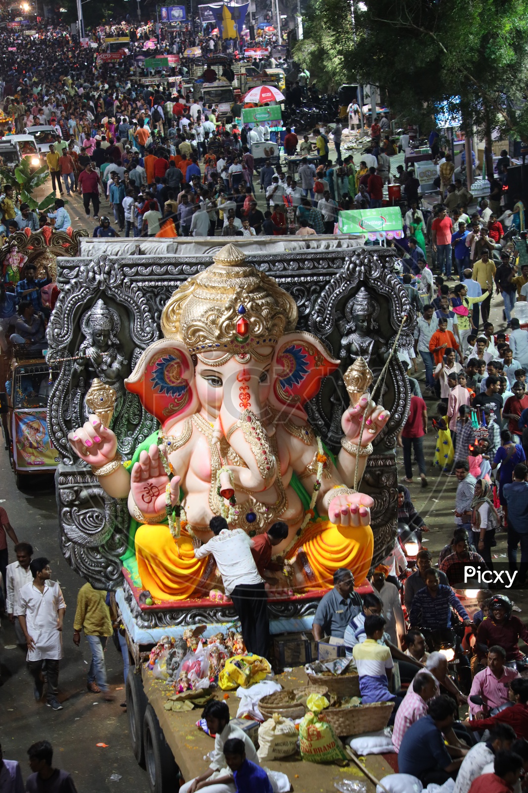 Ganesh Idols In Trucks And Crowd Of Devotees  At Tank Bund For Immersion in Hussain Sagar Lake  During Ganesh Visarjan Or Nimarjan  Event In Hyderabad