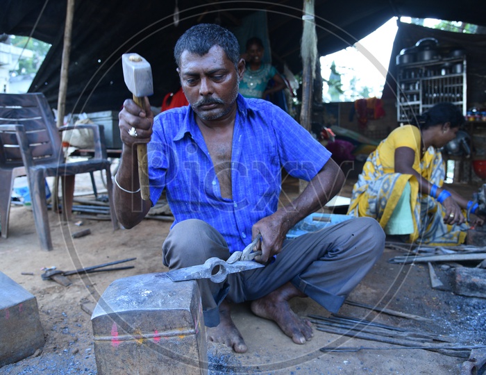 Indian Blacksmith Shaping the Iron Axe Blade using Hammer
