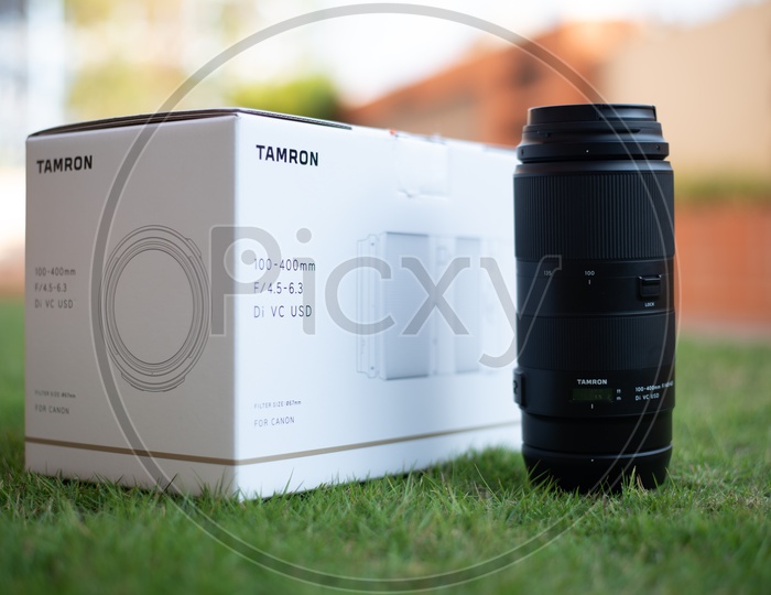 Tamron 100-400 mm DSLR Lens With Box Over Lawn Grass Backdrop