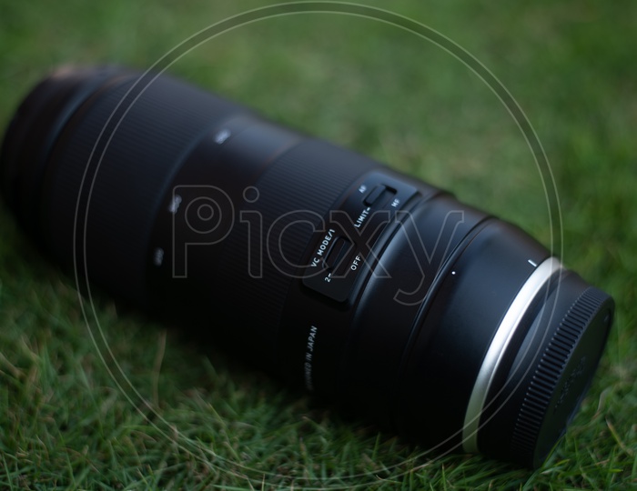 Tamron 100-400 mm DSLR Lens Over Lawn Grass Backdrop