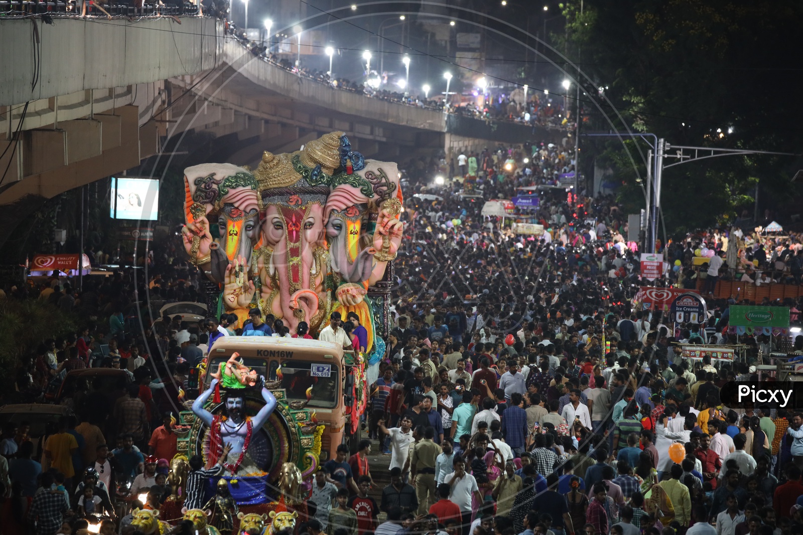 Image of Ganesh Idols In Trucks And Crowd Of Devotees At Tank Bund For ...