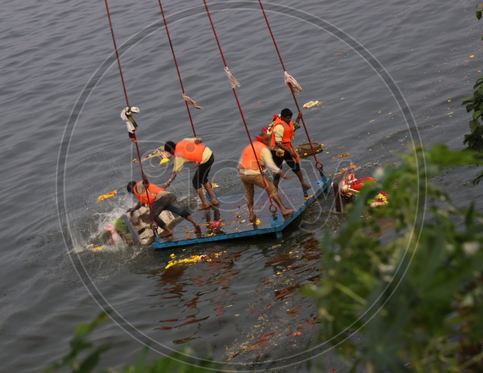GHMC Arranged Workers Carrying Ganesh Idols In Cranes For Immersion in Hussain Sagar  Lake  During Ganesh Visarjan or Nimarjan Event At Tank Bund