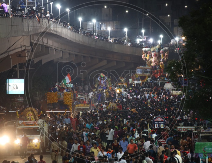 Image of Ganesh Idols In Trucks And Crowd Of Devotees At Tank Bund For ...