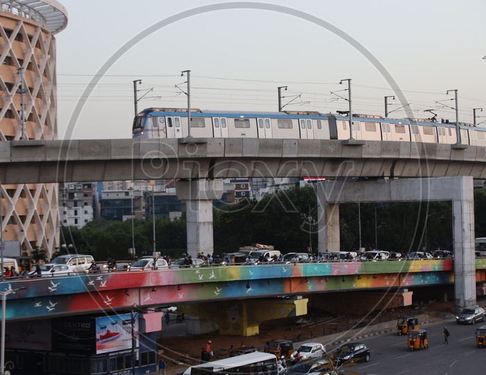 Metro Train Running on Track With Hitech City Flyover Composition