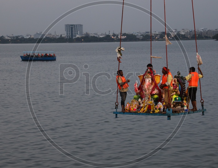 GHMC Workers Carrying Lord Ganesh Idols In Crane For Immersion In Hussain Sagar Lake  During Ganesh Visarjan or Nimarjan Event At Tank Bund