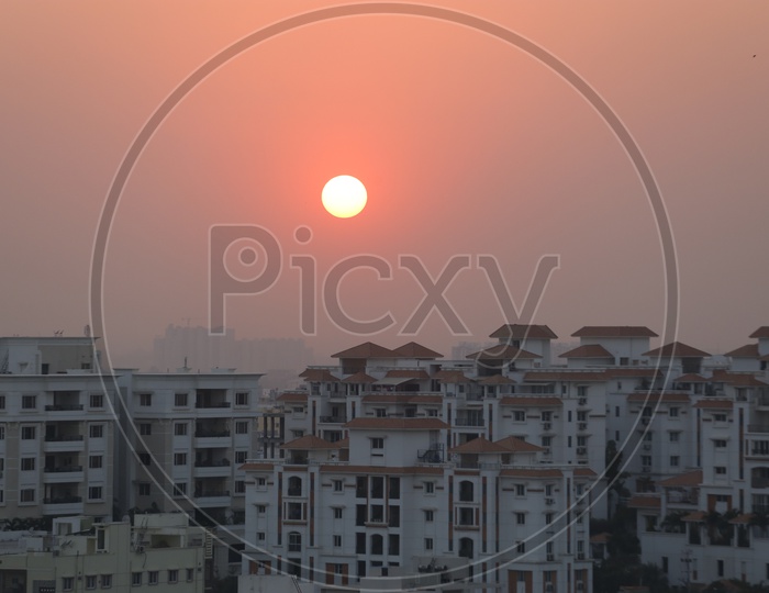 Sunset Over High Rise Buildings Or Apartments Closeup