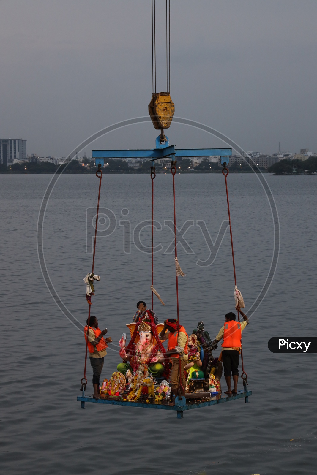 Image of GHMC Workers Carrying Lord Ganesh Idols In Crane For Immersion