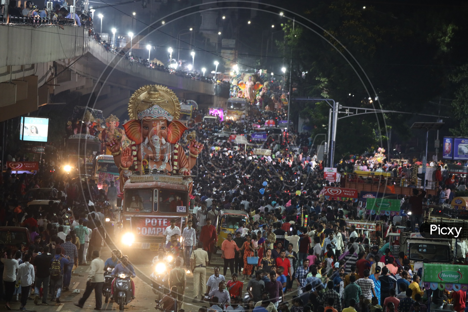 Image of Ganesh Idols In Trucks And Crowd Of Devotees At Tank Bund For ...