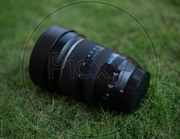 Tamron Sigma 15-30 mm DSLR Lens On Lawn Garden Grass Backdrop