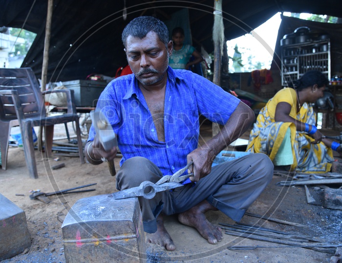 Indian Blacksmith Shaping the Iron Piece using Hammer