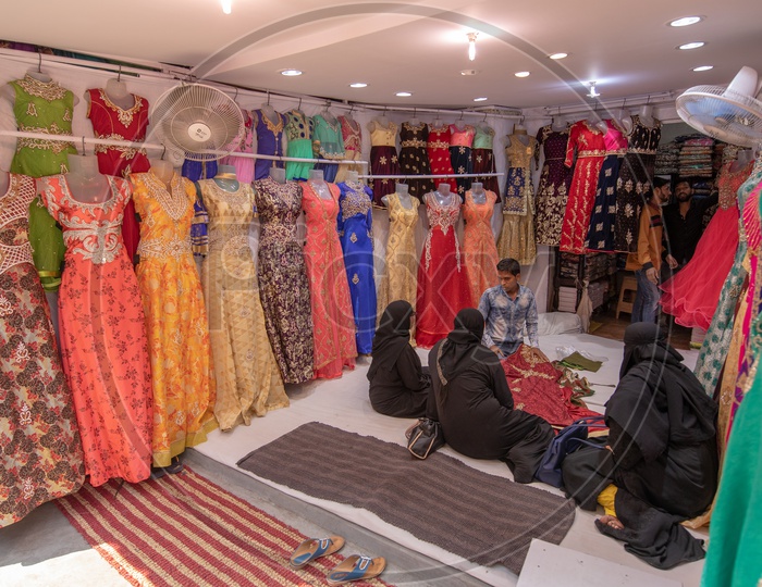 Muslim Woman Shopping Clothes In a Store