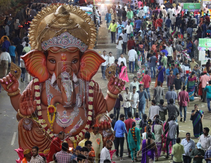 Image of Ganesh Idols In Trucks And Crowd Of Devotees At Tank Bund For ...