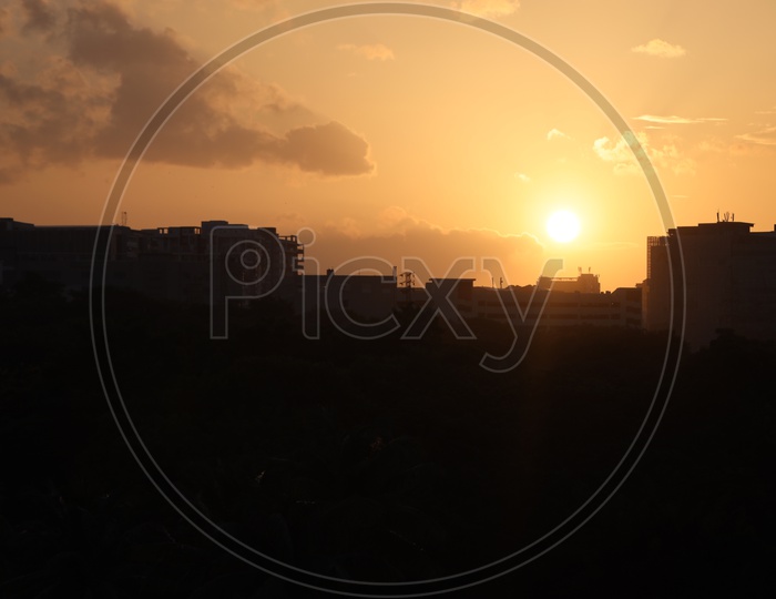 Silhouette of High Rise Buildings With  Sunset Sky in Background