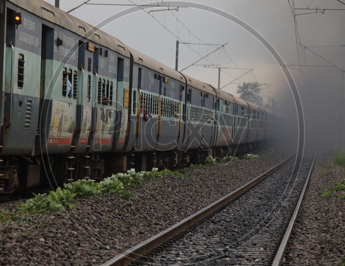Indian Railways Train Moving on Track Lines With Electric Poles And Wires