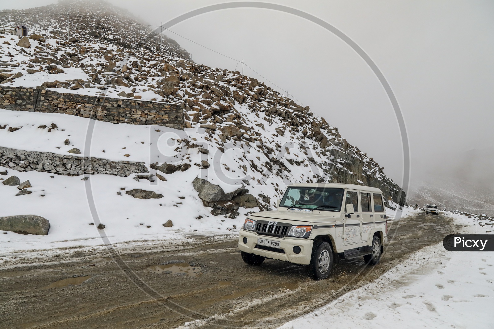 XUV Car in The Roads At Snow Capped Mountains At Ladakh
