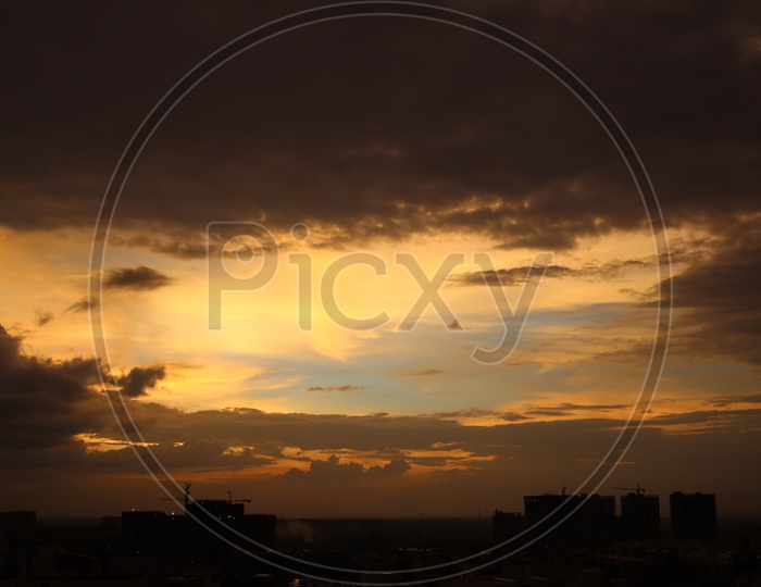 Hyderabad City Scape with Dark Clouds In Sky With Golden Hour Sunset Colour Pallet  Forming a Background
