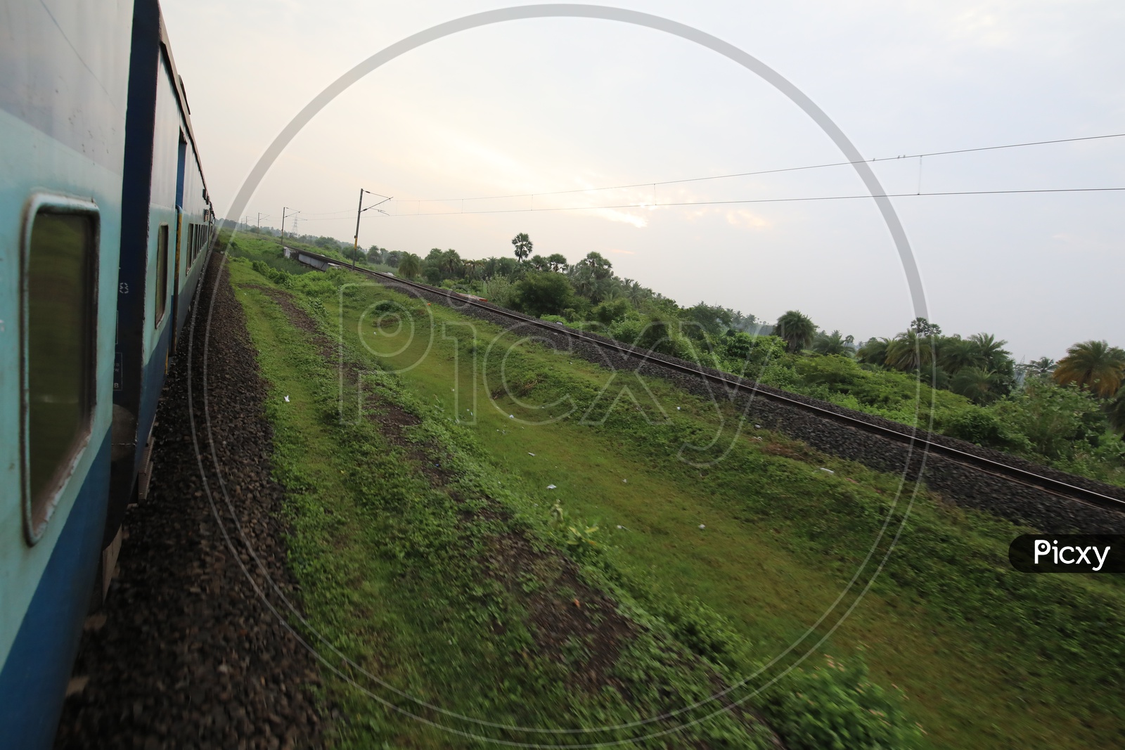 Indian Railways Train Running On Track Lines With Electric Poles and Wire Lines
