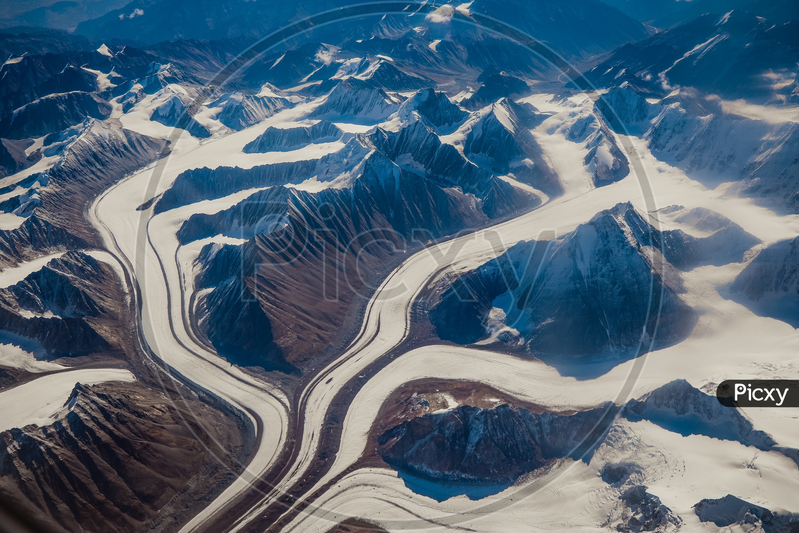 Aerial View Of Valleys And Snow Capped mountains in Ladakh From Flight Window