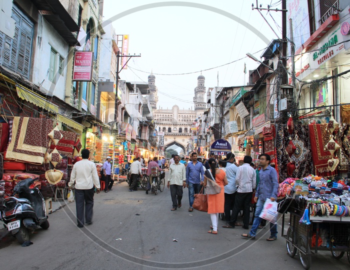 Busy Ghansi Bazaar Street With Visitors Shopping In Bangle Shops With Charminar In Background