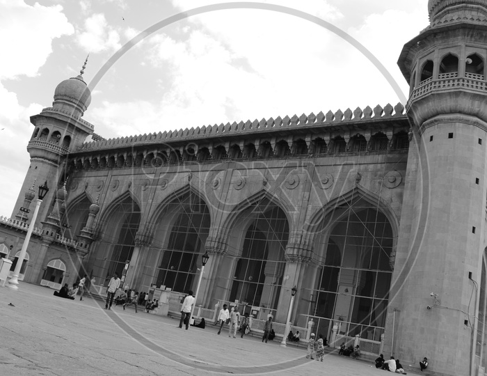 Mecca Masjid With Visitors In Compound With Sky in Background