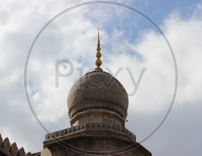 Mecca Masjid Dome With Pigeons With Sky in Background