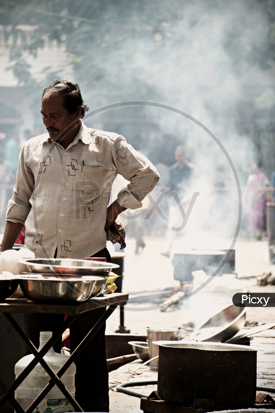 a man cooking food for people
