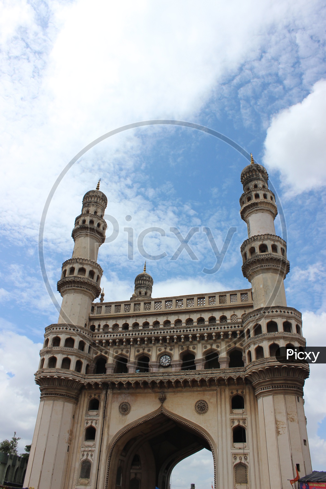 Majestic Charminar With Pillars Composition Over Blue Sky With Cotton Clouds Background