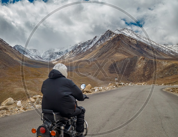 Bike Traveler Riding Bike On Ghat Roads Leading To Mountains