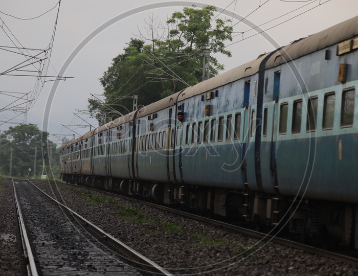 Indian Railways Train Moving on Track Lines With Electric Poles And Wires
