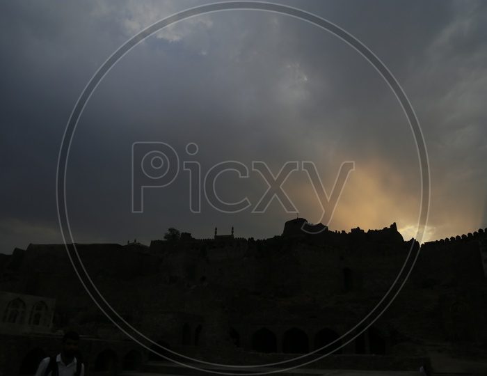 Silhouette Of  Golconda Fort Canopy Over Sunset Sky Background