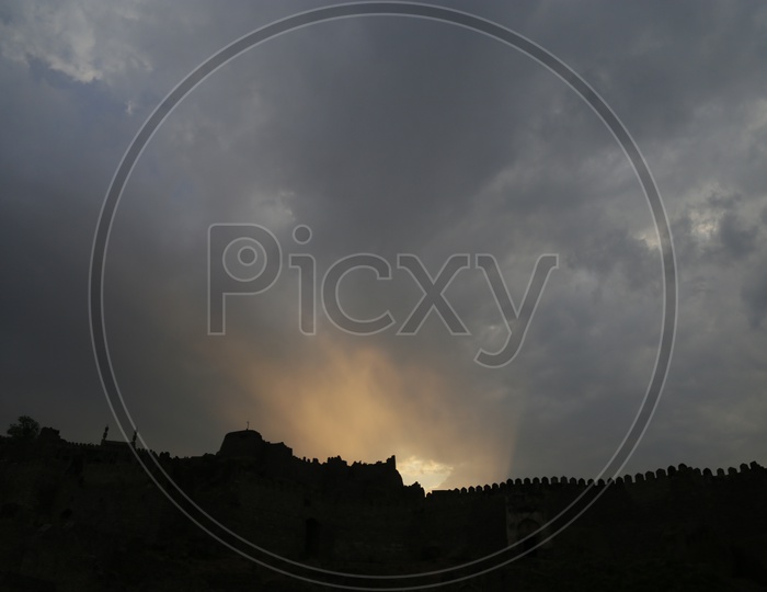Silhouette Of  Golconda Fort Canopy Over Sunset Sky Background