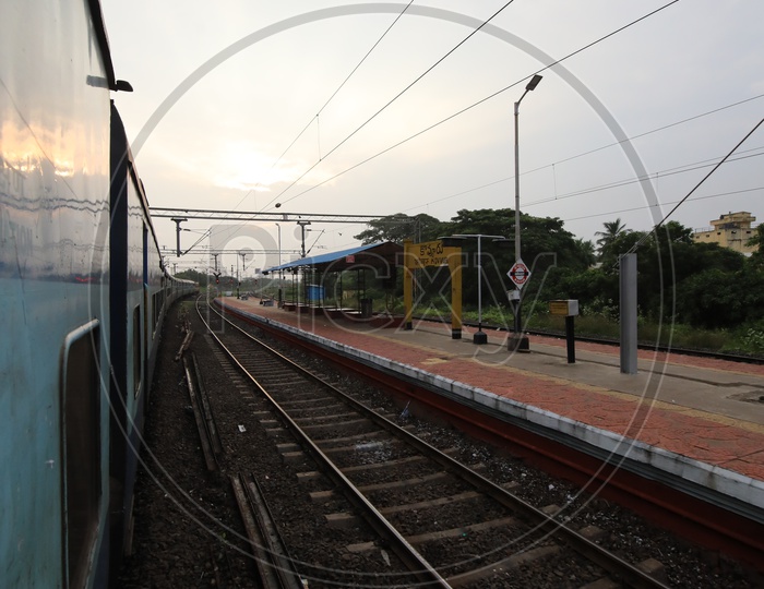 Indian Railways Train Running On Track Lines With Electric Poles and Wire Lines