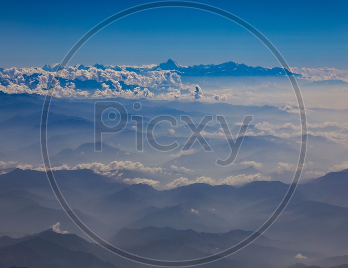 Aerial View Of Valleys And Snow Capped mountains in Ladakh From Flight Window