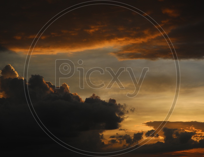 Dark Clouds In Sky With Golden Hour Sunset Colour Pallet  Forming a Background