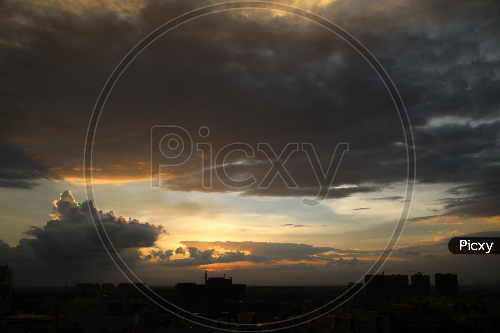 Silhouette Of  High Rise Buildings Over City Scpae With Sunset  Sky Background