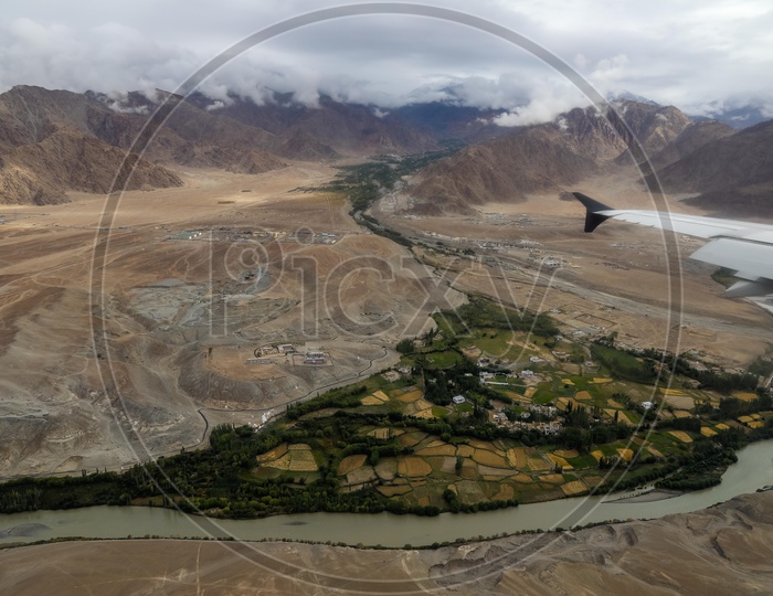 Aerial View Of Mountain Passes And River Valleys In Ladakh From Flight Window